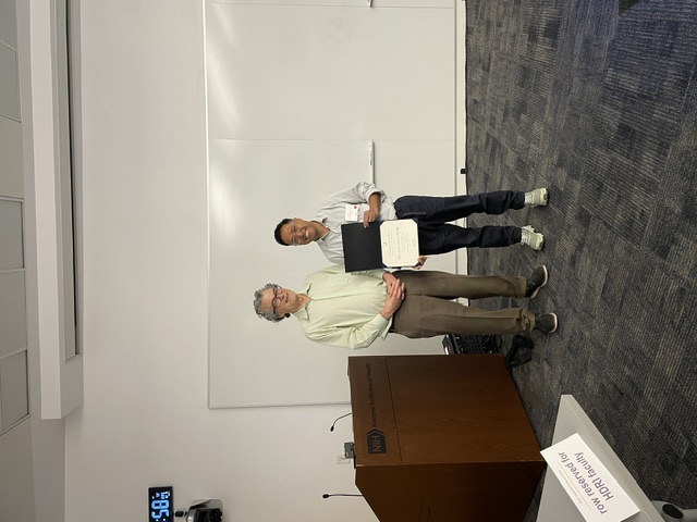 Dr. Tolentino receives his certificate from the institute&rsquo;s director.