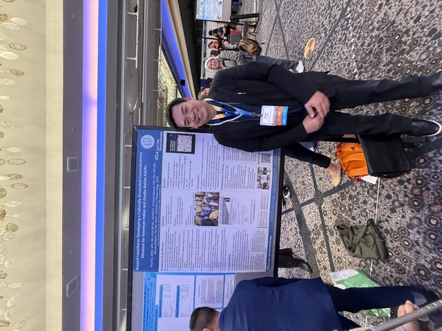 Paul presents one of several posters, including work on loneliness.